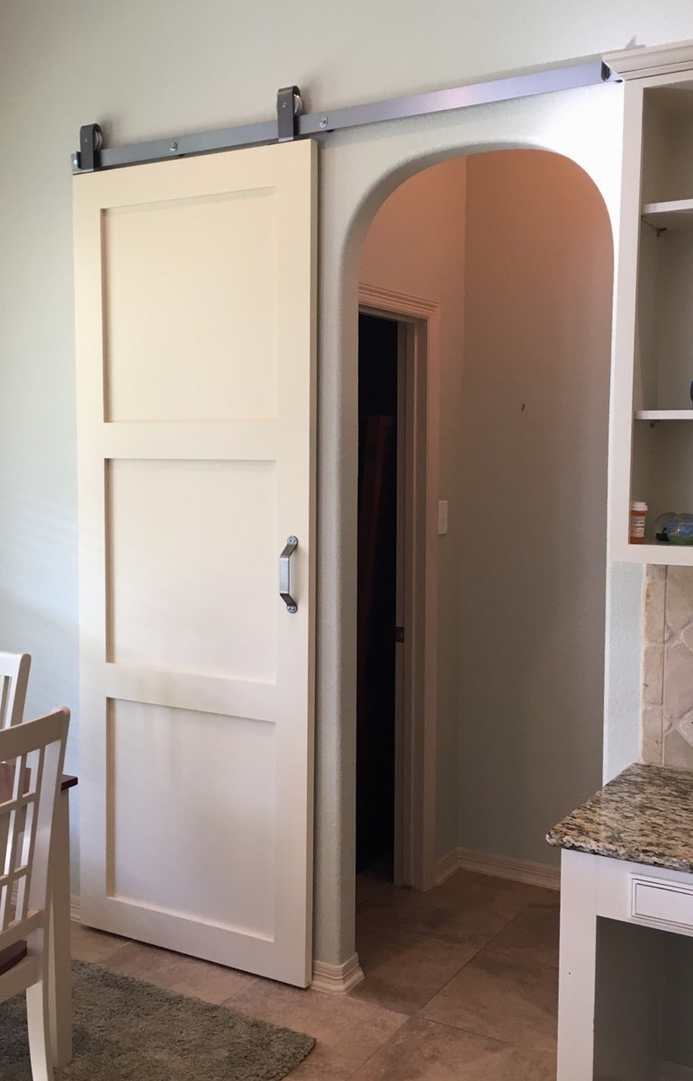 Shaker style barn door in Charlotte kitchen.